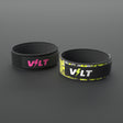 VOLT NovaBelt in Pink and IronBelt in Original, the 4 inch weightlifting belt in two of its four finishes, on a grey rubber floor