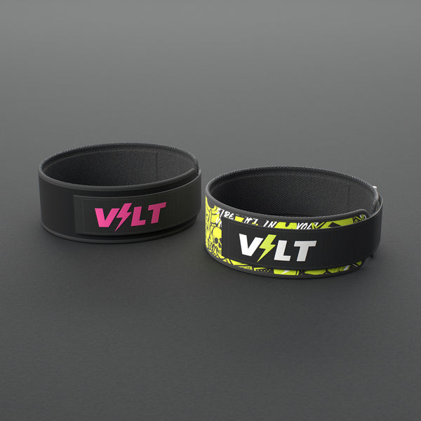 VOLT NovaBelt in Pink and IronBelt in Original, the 4 inch weightlifting belt in two of its four finishes, on a grey rubber floor