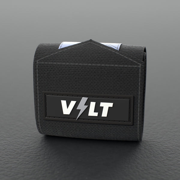 VOLT elastic wrist wraps, BlackEdition (grey print), one wrap rolled up on a grey rubber gym floor #BlackEdition