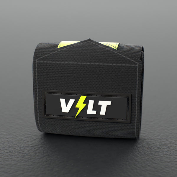 VOLT elastic wrist wraps, Original (lime print), one wrap rolled up on a grey rubber gym floor #Original