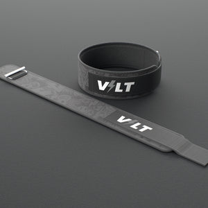 VOLT IronBelt 4" weightlifting belt, BlackEdition (grey print), one fastened and one laid flat, on a rubber floor #IronBeltBlackEdition