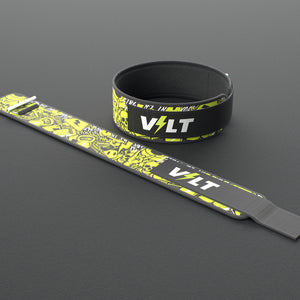 VOLT IronBelt 4" weightlifting belt, Original (lime print), one fastened and one laid flat, on a rubber floor #IronBeltOriginal