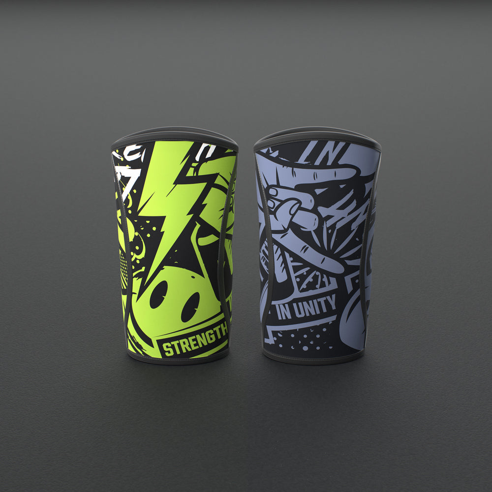 VOLT knee sleeves, one Original (lime print) and one BlackEdition (grey print), standing on a grey rubber gym floor