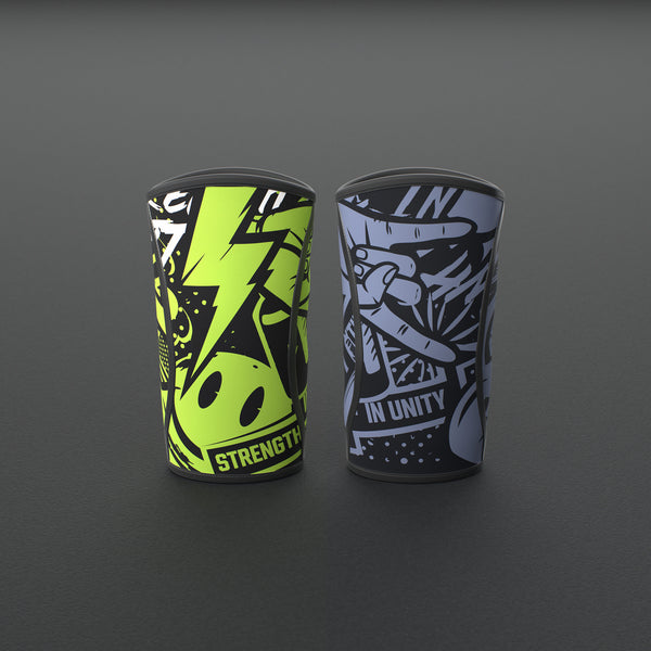 VOLT knee sleeves, one Original (lime print) and one BlackEdition (grey print), standing on a grey rubber gym floor