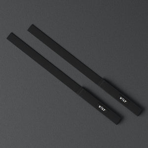 VOLT lifting straps, BlackEdition (grey bolt), a pair laid flat, from above, on a rubber floor #BlackEdition