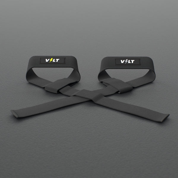 VOLT lifting straps, one Original (lime bolt) and one BlackEdition (grey bolt), on a grey rubber gym floor