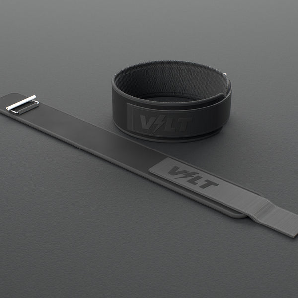 VOLT NovaBelt 4" weightlifting belt, BlackEdition (black VOLT logo on black), one fastened and one laid flat, on a rubber floor #NovaBeltBlackEdition