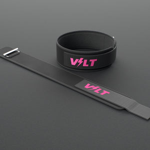 VOLT NovaBelt 4" weightlifting belt, Pink (pink VOLT logo on black), one fastened and one laid flat, on a rubber floor #NovaBeltPink