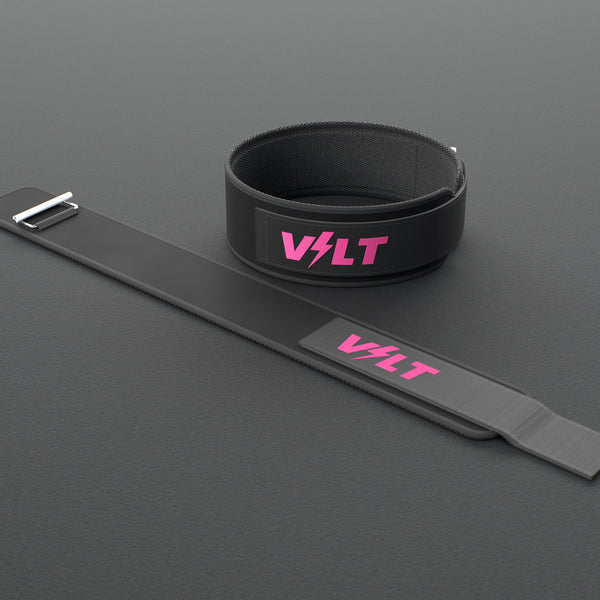 VOLT NovaBelt 4" weightlifting belt, Pink (pink VOLT logo on black), one fastened and one laid flat, on a rubber floor #NovaBeltPink