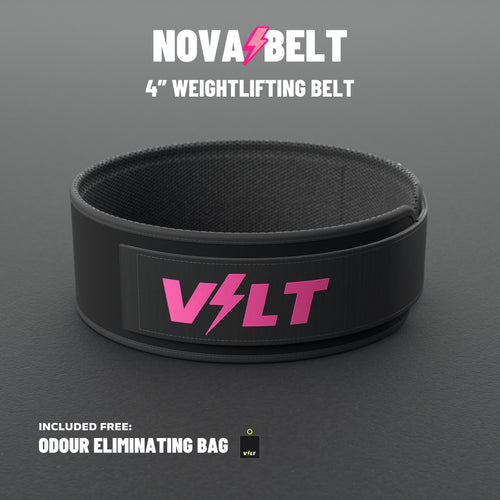 VOLT NovaBelt 4" weightlifting belt, Pink (pink VOLT logo on black), standing on a grey rubber gym floor #NovaBeltPink