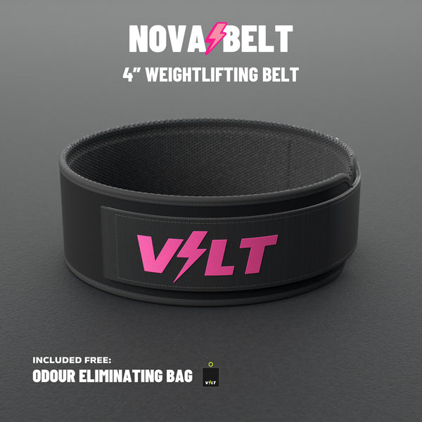 VOLT NovaBelt 4" weightlifting belt, Pink (pink VOLT logo on black), standing on a grey rubber gym floor #NovaBeltPink