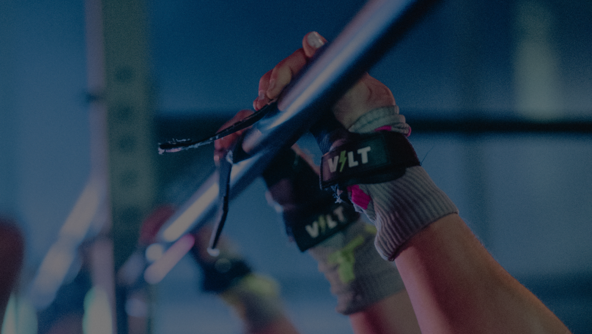 A train.VOLT athlete on the rig wearing UltraGrip+ grips